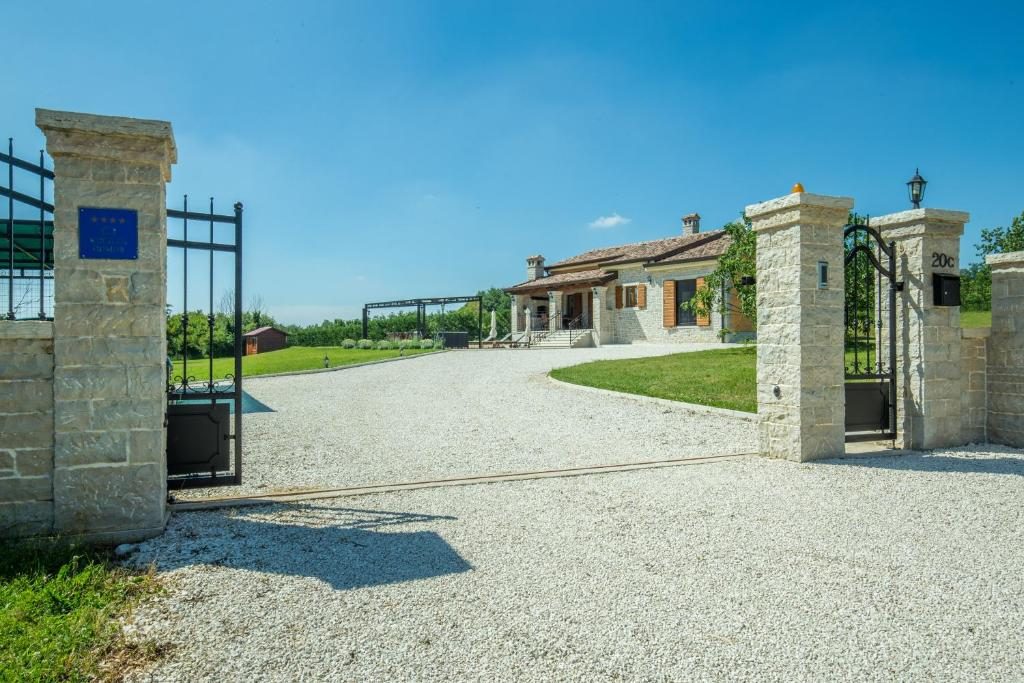 Kameni ulazni portal i šljunčani prilaz Villi Elidi
